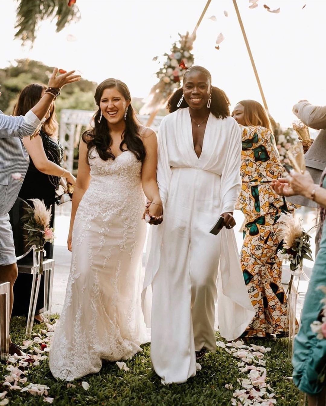 Costa Rica destination wedding ceremony recessional with two brides in modern bridal fashion